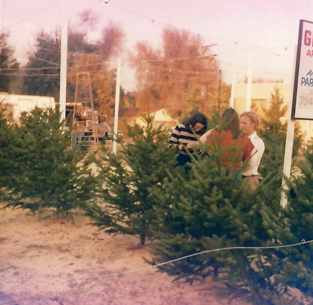 People gathered among Christmas trees at an earlier Tina’s Trees lot